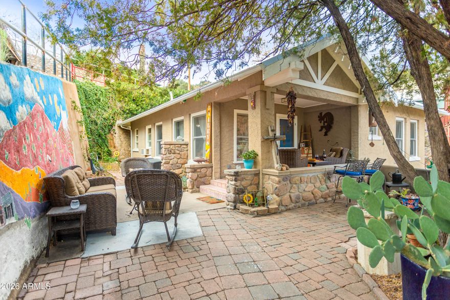 This 1910 home features the best views of historic Bisbee, privacy of a large lot, and 2 private parking spots. The front entrance opens into a charming courtyard, perfect for entertaining. Original built-ins, hardwood floors, woodwork, large walk-in closets, a custom queen-size murphy bed, and a custom copper-surround shower are a few of the unique details that make this property stand out. Beyond the front courtyard, the property continues into a beautiful, irrigated tiered garden, planted with water-wise plants. Located close to cafes, shops and restaurants, the location is both private and convenient. New metal roof in Oct 2019. Upgraded 200amp electric panel in 2016. The City of Bisbee recently replaced the sewer cleanout and paved road.