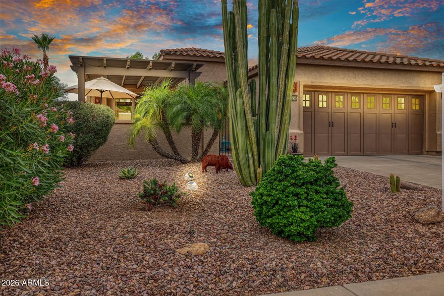'' It's where you belong''. Nestled on this very private lot in one of Peoria's finest neighborhoods, the Award Winning Trilogy at Vistancia Community, this home awaits. Upon arrival, you enter thru a spacious courtyard that features a lighted Pergola, inviting seating that surrounds a cozy firepit.   Inside this popular open floor plan, the great room beckons with comfortable seating, a large screen TV, and delightful views of the lush backyard. Adjacent and overlooking, is a chef's delight efficient kitchen with lots of counter space, a serving/prep island, a gas cook-top, a spacious pantry, pull-out drawers, and a breakfast nook that overlooks the lighted front courtyard.  The Primary bedroom and adjacent bath is filled with natural light, his and her sinks, a walk-in closet and a large easy entry shower. Down the hall is a Den or possible third bedroom with an upscale sliding closet door.  The 2nd bedroom/guest suite is large enough for a queen bed, has an adjacent bath, and offers a private comfy place for those out of town guests  The backyard impresses with a travertine tile patio with seating around an inviting firepit overlooking the lush private backyard with a large shade tree, an ever-producing grapefruit tree, colorful blossoming plants, and a bubbling hot tub for your evening stargazing and relaxation. The garage has an epoxy floor and sports a convenient laundry sink. All of this in a community that lives and feels like a resort with its abundant green areas, 2 clubhouses, 2 resort-size pools, an indoor lap pool, an award-winning 18-hole golf course, pickleball courts, bocce ball, tennis, a play structure for grandchildren and a multitude of group activities with over 40 active clubs. Trilogy at Vistancia is more than just a place to live; it's the place you have always wanted to be.