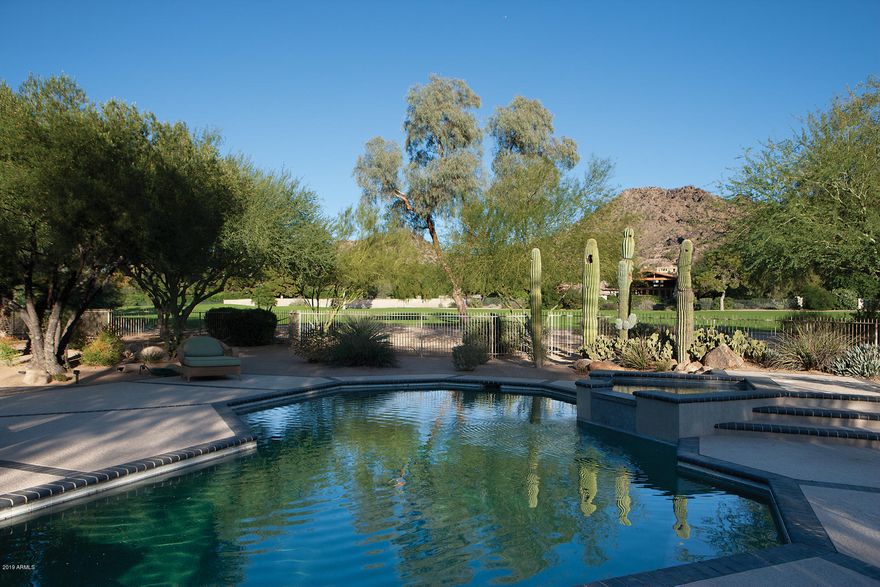 Arizona indoor and outdoor living at its best. This lovely and timeless home is located on almost 1.5 acres, on the 4th fairway of the Paradise Valley Golf course. Nestled at the end of a quiet cul-de- sac street it has 4 bedrooms, 4 baths, office and/or 2nd Master suite. The Family room, with large glass sliding doors, brings the beautiful gardens and covered patio dining area into view. Seldom do homes in this area come on the market and this is a rare opportunity to own one of the best.