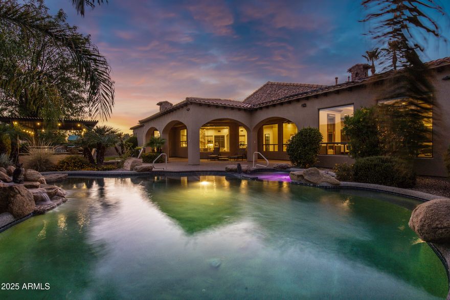 Welcome to your dream estate in the gated community of Vasaro. This luxurious home epitomizes elegance, with no detail overlooked. From the grand entrance to the stunning backyard, every feature exudes sophistication.
Soaring ceilings, exposed wood beams, & custom finishes throughout. An open-concept Great Room connects seamlessly w/formal dining area, wine room, kitchen, & game room. A gallery hallway leads to the owner's suite, featuring gas fireplace, dual closets & vanities, plus a bonus room. The guest wing includes an office, loft area & 3 bdms w/walk-in closets, one with an ensuite bathroom.  Outside your backyard oasis is complete w/large play pool, custom rock features, & spa. Entertain on paver patios, w/built-in BBQ, & play area w/artificial turf.