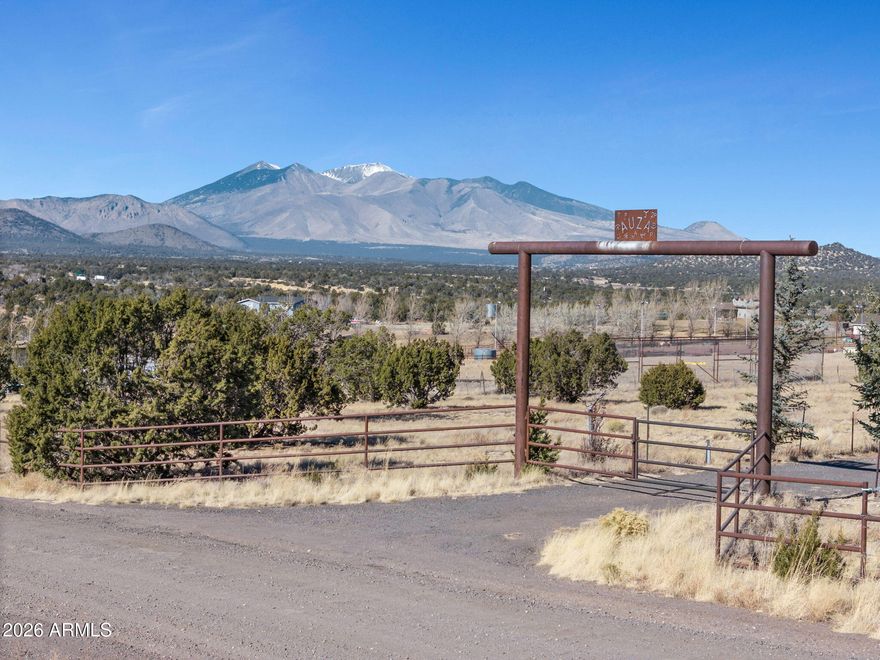 ABSOLUTELY PERFECT 10 ACRE HORSE PROPERTY. This turnkey equestrian facility offers stunning peak views, a 175'x335' pipe fence arena complete with lead-ups and cattle pens that include loafing sheds. The property features nine shed-row stalls, each with dedicated water and power. Storage includes a 120'x15' concrete-floored hay barn and storage area, as well as a four-horse hot walker barn. The entire parcel is enclosed by perimeter fencing and cross-fencing constructed with authentic Texas Cedar stays, topped with a hot wire system. The property entrance is marked by an impressive 12-inch diameter pipe overhead. Utilities include three-phase power, a 1/20th share in a deep well, 10,000 gallons of water storage, and drip irrigation at the main entrance. A significant 8-foot retaining wall with imported fill creates a large, level area, including a batting cage. As an added benefit, the property is directly adjacent to National Forest land.