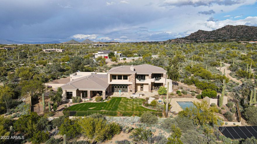 Pristine 5 Acre North Scottsdale Estate near some of the BEST golf, biking, hiking & dining Scottsdale has to offer! Walking distance to Pinnacle Peak hiking trail, near Troon North & Estancia golf. Feel like you're on vacation everyday in this gorgeous custom home featuring 5,976 square feet of ample open living space, 5 bedrooms, 5 bathrooms, gourmet chef's kitchen with large entertaining island, wine cellar, 4 car garage with NO HOA! ''Oasis in the desert'' Spectacular heated pool & spa with two outdoor fireplaces for soaking up the warm Arizona sun all year long, then finish the evening enjoying the spectacular city views!