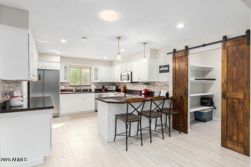 **Resort-Style Living in the Heart of Old Litchfield Park - No HOA!**
Welcome to the highly sought-after Wigwam community, where timeless charm meets luxury lifestyle. Located in the heart of Old Litchfield Park, this beautifully updated 4-bedroom, 2.5-bath home offers the rare opportunity to live in one of the West Valley's most desired golf course communities--without the restrictions of an HOA.
Enjoy access to the world-renowned Wigwam Resort, featuring **three championship golf courses **resort-style amenities, dining, and exclusive golf packages. This is true golf cart community living, where you can cruise to dinner, the course, or local events with ease. Inside, the home offers spacious living with soaring vaulted ceilings, skylights, and an open, inviting layout. Designer touches include staggered large-format ceramic tile, updated fixtures, and abundant natural light throughout. The kitchen is built for both function and entertaining, featuring granite countertops, a wet bar, and a large walk-in pantry with custom barn doors.
The family room is warm and inviting with a two-way gas fireplace, perfect for cozy evenings or entertaining guests. The expansive primary suite offers a true retreat, complete with two large walk-in closets and a private exit to the backyard.
Step outside to your private oasis--designed for Arizona living. Enjoy a heated pool and in-ground spa, large covered patio, and low-maintenance artificial turf, all supported by a commercial-grade irrigation system.
Additional features include an indoor laundry room with storage, updated windows and doors, and a functional layout ideal for both everyday living and entertaining.
Beyond the home, you'll love the lifestyle this community provides--tree-lined streets, walking and biking paths, top-rated schools, and nearby dining and shopping, with even more growth and development coming to the area, including the exciting Litchfield Park Square.
Opportunities like this in Old Litchfield Park are rare--resort-style living, golf community access, and no HOA.
