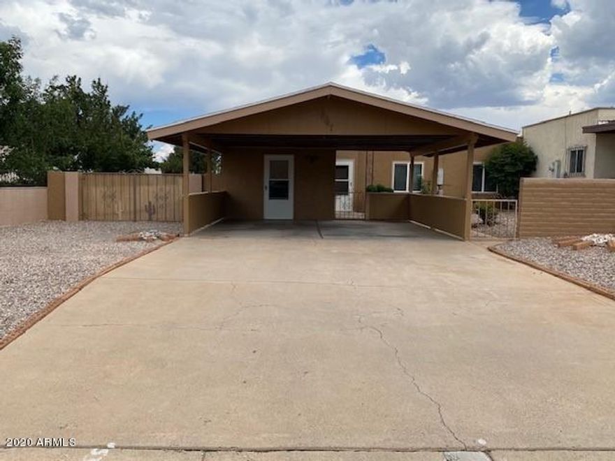 Don't miss this cute townhouse on a very large lot (2nd biggest in the  neighborhood ) with a beautifully landscaped courtyard, RV parking, two car carport and grass back yard with fruit trees. This home has 3 bedrooms, 2 baths, large living room with a fire place, a Arizona room.  Seller is offering a Home warranty for the first year.