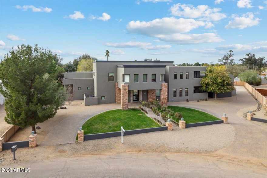 This one-of-a-kind custom home is located on over an acre in the heart of Scottsdale. This fantastic home was designed and built by the current owners and no stone was left unturned. Pull up to the grand entrance and enter into this expansive great room with soaring ceilings and wonderful flow for entertaining. Complete with a beautiful bar area and temperature-controlled wine room. The space also features a gourmet kitchen with custom cabinets and gourmet appliances. The functional split floorplan has the master and one additional room on one side and three bedrooms on the main floor as well. Upstairs features a theatre room and a large loft perfect for game night. The home also features a permitted and grandfathered guest house/shop that has pass through garage doors in the shop area as well as a kitchenette, bath, and living space. This space could make an awesome pool house, guest quarters, shop and more. The backyard is an entertainer's delight with outdoor kitchen, sparkling pool, gazebo, plenty of grassy play are for kids and/or pets and more. The home features so many touches you would normally only see in more expensive homes such as an elevator, sauna and even an observatory space. This checks all the boxes!