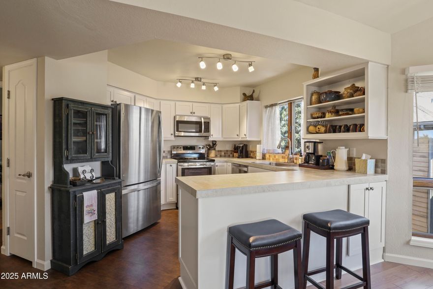 Welcome to this beautifully updated 2-bedroom, 2-bathroom condo nestled on the 3rd floor, offering 1,350 square feet of modern comfort and style. Step inside to find elegant vinyl plank flooring throughout, an updated kitchen with contemporary finishes, and sleek, remodeled bathrooms. The open-concept living and dining area is highlighted by soaring vaulted ceilings and a cozy wood-burning fireplace--perfect for relaxing evenings. Step out onto your private, covered balcony and take in the serene mountain views. Enjoy a host of community amenities including a sparkling pool, putting greens, and sports courts. Whether you're entertaining guests or simply soaking in the scenery, this condo offers a perfect blend of comfort and lifestyle.