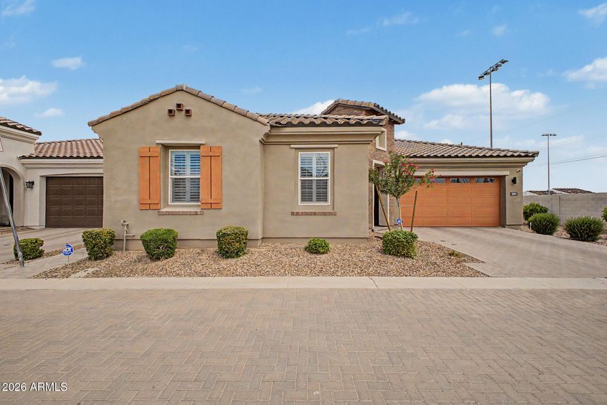 Highly upgraded home with designer finishes and premium custom features throughout. Chef's kitchen includes stacked navy cabinetry, KitchenAid appliances, double ovens, 36'' cooktop/hood, oversized refrigerator, gold fixtures and upgraded lighting. Backyard features paver patio, outdoor speakers, water feature, string lights, irrigation, custom slider screen, doggy door, and lighted turf dog run. Smart/electrical upgrades include in-wall TV wiring, LED lighting, dimmers, WiFi extenders, built-in speakers, multi-zone receiver/amp, Google cameras, ADT security. Plantation shutters, blackout/roller shades, upgraded laundry room, garage storage, reverse osmosis, EV charging, custom primary bath vanity, and dining room bar with wine fridge, ice maker, quartz counters.