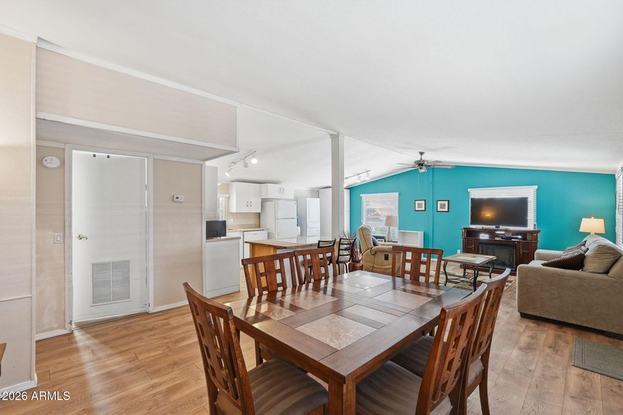 Beautiful, turnkey ready 55+ community home! This fully furnished, ground-set doublewide features a clean updated style, w/ a versatile kitchen island, a new refrigerator, additional kitchen cabinets, plus a formal dining room.  Enjoy a bright, open layout with front picture windows, a separate laundry room, and two walk-in showers. Outside offers a full length covered patio with a table, plenty of chairs, and a built-in TV! Additionally, there is a 2 car carport and a storage shed. Great pet-friendly community with a pool, hot tub, and clubhouse. Near shopping and dining, with easy freeway access! Lot rent $780 mo + water.