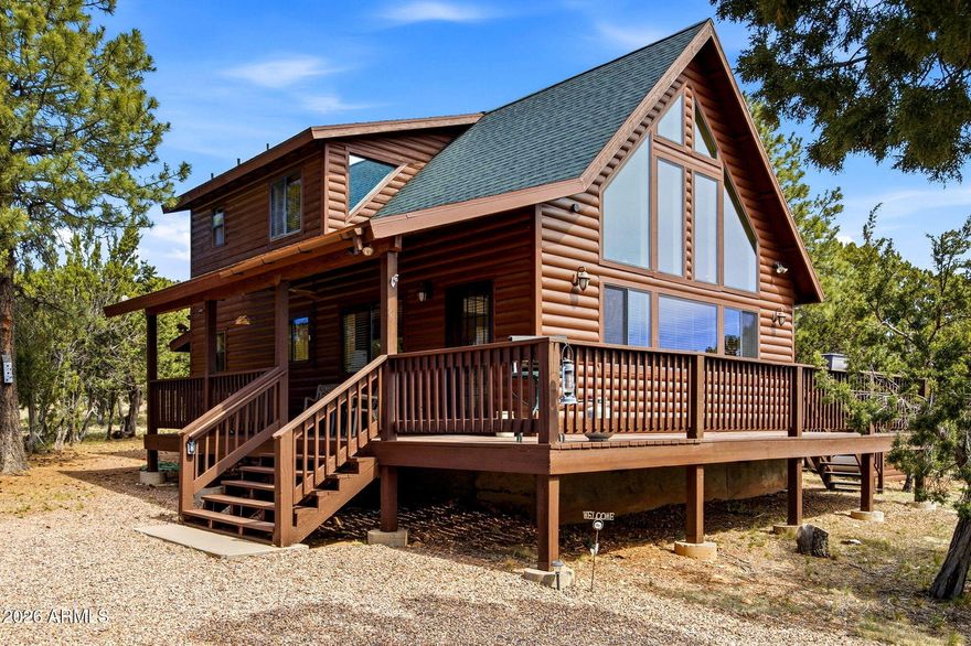 Charming chalet-style home in the desirable High Country Pines HOA community with nominal dues! Situated on a heavily treed .57-acre double lot, this property offers privacy, spectacular views, and two driveways in a quiet neighborhood with paved streets. Featuring a rustic log façade with peel pole log and rope accents, this 2 bdrm, 2 bath home includes an upstairs master with full bath and an open loft. Recently replaced front windows enhance natural light, while laminate wood floors, a T&G vaulted ceiling, and a stone-faced wood-burning fireplace create a warm, inviting interior. Enjoy an open kitchen, dining, and living room layout perfect for entertaining, plus covered and uncovered decks to take in the scenery. Complete with a detached 2-car garage and storage shed, this mountain retreat offers both comfort and functionality.