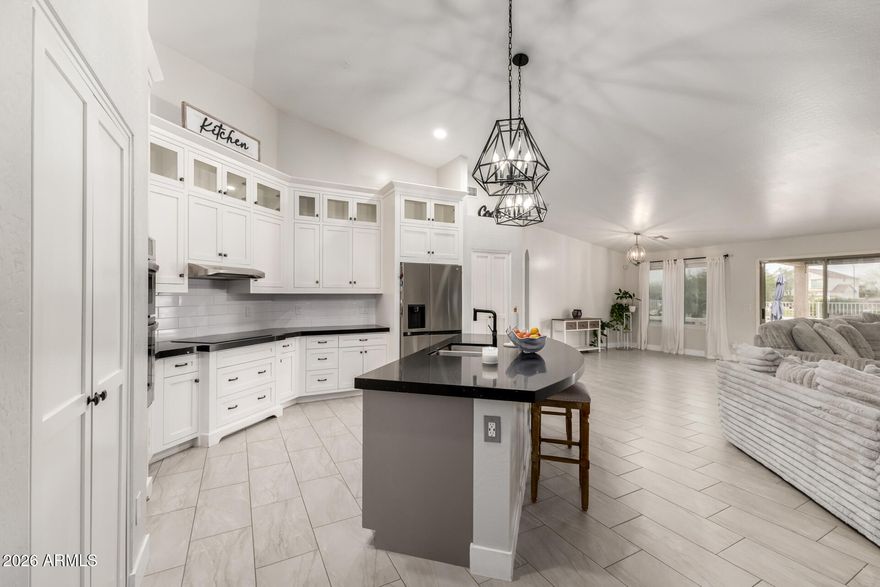 Recently remodeled 2,908 sq ft home with 4 bedrooms, 2 baths, office, and a sparkling pool! Open-concept layout features a custom Stone Creek kitchen with quartz counters, new cabinets, upgraded appliances, porcelain tile, and Anderson windows and shades. Tastefully updated bathrooms, central vac, owned Kinetico water softener, new insulated garage door, and updated fixtures throughout. Private backyard oasis with new landscaping, covered patio, outdoor island, fire pit, no neighbors behind, and breathtaking Arizona sunsets. Easy I-10 access—approx. 30 minutes to Chandler and Phoenix. Move-in ready and a must-see!