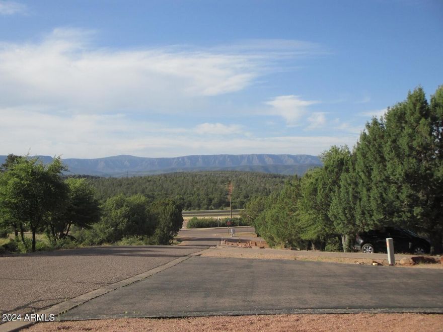 Great view lot with unobstructed views of town and the Granite Dells. All utilities at the street. No HOA. There is a 2000 sq.ft. minimum requirement on home size. Property is secluded and private.
