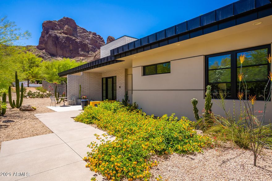 Dream View! This Modern contemporary home in the heart of Paradise Valley located in this most desirable neighborhood has the in-demand features for today! Inside: honed concrete floors throughout, all on one level. Walnut veneer millwork, 24' stacking slider for indoor/outdoor living. Top-line appliances, open great room concept. Large kitchen island, leather finished stone top plus quartz counters. Bedrooms all w/en-suite baths. Large Owners suite makes this ''perfect sized''. Outside: white honed block, crisp steel detail steel, timeless desert design. Views will astound you! Large pool, manicured synth-lawn w/putting green, mature palms. Solar array for great rate! 3-car garage w/frosted glass doors. Come for the view, stay for the quality!