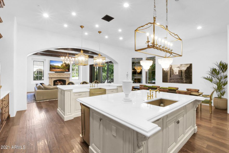 Sale includes 7,644 sf HOME on 30,064 sf lot PLUS  33,396 sf ADJOINING LOT WITH IT'S OWN parcel number 314-04-497. TWO PARCELS BEING SOLD AT THIS PRICE PLUS, all within the Southeast Valley's most sought after and sold out gated community. This estate has undergone an extensive modernization and top to bottom remodel! New custom lighting is exquisite! Custom chef's kitchen, custom hand made cabinetry and commercial grade appliances. Soaring ceilings, sweeping staircases, grand foyer & enormous roll open doors bring the inside living to the outdoors. EVERY BEDROOM has on suite bath, private washer & dryer & walk in closet!  Your family will LOVE the game room! Backyard feels like a private resort w/enormous outdoor living room w/fireplace and misters. You don't feel like you're in AZ when.. you walk into this backyard! Mature trees, beautiful vegetation and vines, tree swings, hammocks and no neighbor in your back yard.  WOW! This ESTATE property is impressive! You're getting two lots so you can choose to build on second lot should you choose, but let me make it clear, there are two separate parcel numbers being sold. One includes the existing home and the other currently is being used as part of the existing backyard, but could absolutely be built on. Call Jody for more details and come see this one today, before it's gone!
