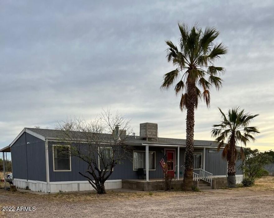ADORABLE 3 bedroom/2 bathroom home on over 2 acres with AMAZING mountain views! Large master with walk-in closet, open floor plan and great roomy kitchen. Have fun with the chalkboard wall in one of the bedrooms!  Interior recently painted. Warm up on those cool winter evenings by the wood burning stove or enjoy a beautiful Arizona sunset over the Huachuca's on the front covered porch. Large carport and covered patio in back. Call to view this cute home before it's gone!