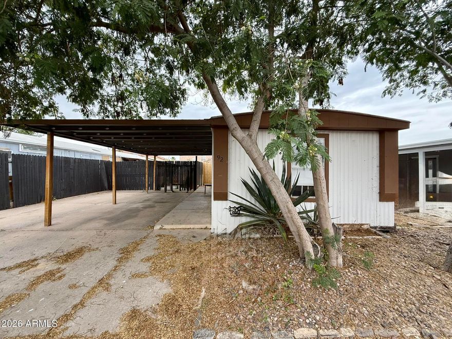 Opportunity meets functionality at 1802 E Campo Bello Dr, Lot 92 in the all-ages Shadow Hills community. This 1-bedroom, 1-bath home offers a rare combination of indoor livability, outdoor space, and value-add potential--making it an ideal fit for both end users and investors alike.

Inside, you'll find a surprisingly open layout with updated flooring throughout and a spacious living area that flows seamlessly into the kitchen. The kitchen offers ample cabinetry and workspace, providing a solid foundation for future updates without the need for a full overhaul. One of the standout features of the home is the beautifully remodeled bathroom, complete with an oversized walk-in tiled shower that delivers a modern, high-end feel not typically found at this price point. The large walk-in close adds additional functionality and storage.

Step outside and the true differentiator reveals itself--an expansive, fully fenced yard that is rarely available in this community. Whether you envision a garden, pet-friendly space, outdoor entertaining area, or simply room to spread out, the possibilities here are endless. The oversized double carport provides generous covered parking, while the large detached shed/workshop offers incredible flexibility for storage, hobbies, or workspace needs.

While the home does need some TLC, many of the key elements are already in place--allowing the next owner to focus on cosmetic improvements and personalization rather than starting from scratch. With a motivated seller and strong underlying features, this property represents an excellent opportunity to create value and make it your own.

Shadow Hills offers an all-ages lifestyle with amenities including a community pool, heated spa, dog park, basketball and volleyball courts, picnic areas, and organized community events.