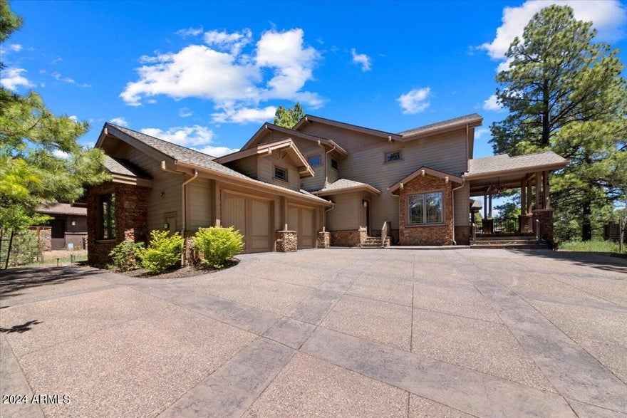 Timeless estate built of quality finish and heart of homeownership. Stunning home with breathtaking views surrounded by serene pine trees and wildlife. This exquisite home blends craftsmanship and meticulous attention to detail throughout. Enjoy fabulous views of a nearby lake, the picturesque 11th hole, majestic mountains, and lush trees from nearly every window. The residence features an abundance of natural light, dual primary suites, two additional bedrooms, a study adjacent to the spacious loft, providing ample space and versatility. The beautiful hickory floors complement the rustic elegance of stone fireplaces and art niches, creating a warm and inviting atmosphere.The gourmet kitchen is a chef's dream, complete with top-of-the-line Wolf and Sub-Zero appliances, a stone countertop, and a large island. This home is a true mountain oasis,  offering luxury living with unparalleled views and premium amenities.