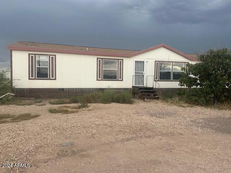 New flooring throughout, Central A/C 1768sq. ft. Fleetwood home. on V.A. Foundation 4 Bedroom 2 bath 2+Acres fenced lot. Off paved road.