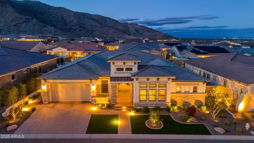MOUNTAIN VIEWS AND PRIVACY define this stunning resort-style home in the coveted 55+ Victory Community, featuring $475,000 in builder upgrades and more than $150,000 in high-end owner upgrades. Offering abundant space for entertaining, along with a quiet and peaceful retreat, this home delivers the best of both worlds: a rare blend of privacy, scale, and refined craftsmanship. A welcoming courtyard entry opens to a bright, thoughtfully designed floor plan featuring all ensuite bedrooms. The kitchen is a true entertainer's delight, showcasing custom lighting, dual ovens, dual-drawer beverage refrigerator, wine fridge, built-in filtered ice maker, and an oversized pantry that provides exceptional storage and workspace. Outdoor living truly shines! The spacious backyard
features a custom-designed pool with striking water and fire features, along with a covered outdoor kitchen complete with a TV and ample seating--perfect for relaxing or hosting gatherings year-round. In-pool seating offers an ideal spot to cool off while enjoying your favorite beverage.
Additional highlights include high-end automated blinds, solar screens, indoor and outdoor speakers, and a hard-wired security system with glass-break sensors for added convenience and peace of mind. The craft room is outfitted with custom cabinetry for effortless organization and includes a built-in Murphy bed for guests. Rounding out the home is a dream garage featuring an upgraded and extended work area, custom cabinetry, elevated storage racks, and epoxy flooring.
While this home is your private OASIS, the community of Victory at Verrado is a place to truly live. Activities and social opportunities abound with newly expanded pickleball courts, tennis, bocce ball, a lap pool, three relaxation pools, a hot tub, sauna, and a well-appointed fitness center. Need to unwind? Enjoy the spa or grab a bite to eat while taking in the incredible views. The Crafts with a View studio offers numerous artistic classes and creative opportunities. Clubs fit nearly every interest, and social gatherings--including comedy nights, live music, and poolside events--fill the calendar year-round.