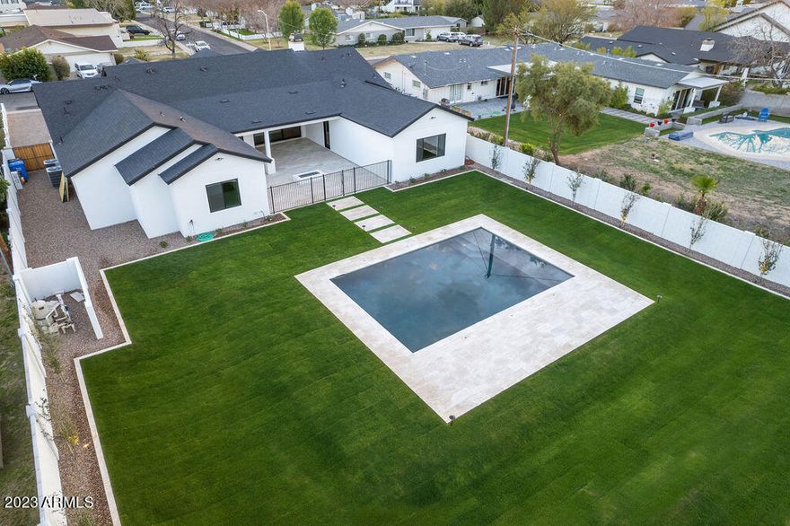 *******VOTED BEST HOUSE ON ARCADIA LUXURY HOME TOUR******

This stunning new construction home is located in Arcadia lite quiet and charming neighborhood with Camelback views right in your back yard.  The home is positioned on a 19,000 sf lot. The house boasts 10ft flat ceilings in all of the house except the great room which has vaulted with exposed beams ceilings. 4 out of 5 bedrooms are en-suite to give privacy to your company and each bathroom having its own custom choices of finishes. You have a 5th room with its own private entrance off the front of the house for your convenience of making it an office.  All of the rooms are surrounding the kitchen, giving you the option of using the dining room or the breakfast nook. The kitchen is finished with two tone cabinetry, walk in pantry, a full Thermador appliance package, including a 24'' wine tower along with 30'' refrigerator and 30'' freezer and topping it off with a 48'' gas range. The home provides just shy of 7,000 sf of grass, new pool and fire pit. Bring your friends and families to enjoy these amenities.
There is plenty more to see in person with a floor plan that has been well thought out along with tasteful finishes throughout.