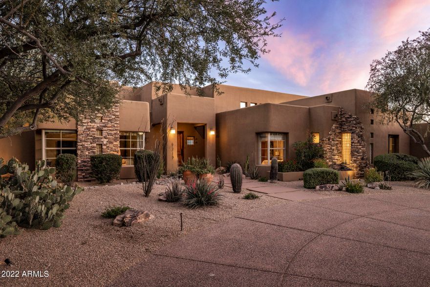 A stunning modern southwest design with 360-degree views beckons as if destiny.  Situated on almost 1 acre in the coveted Pinnacle Peak corridor, this north facing home is a timeless retreat opening to soaring ceilings accentuated with flagstone flooring and natural light softly dancing throughout the open refined design, leading to a family room with fireplace, formal dining room and kitchen with custom oversized island for gathering around.  Hardwood floors flow through all the bedrooms including a spacious master suite with fireplace, expansive walk-in closet and additional private office or fitness room with wet bar.  The split floor plan offers spacious guest bedrooms in the main house as well as includes a detached guesthouse with family room, ensuite bedroom, kitchenette and [MORE] views.  This elegant retreat seamlessly opens to an expansive covered outdoor living space with travertine flooring, multiple seating areas, fireplace, built-in barbecue, beverage cooler, bar, and heated pool.  All perfectly positioned to capture tranquil Sonoran Desert and mountain views.  An upper deck offers stunning 360 views including Pinnacle Peak, McDowell Mountains and more.  This is an exceptional home, complete with 1000 bottle wine cellar, circular driveway plus a private driveway leading to a 3-car garage with a wall of built-in storage.