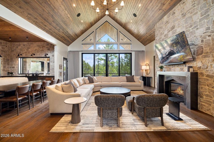 White Mountain Manor -- a one-of-a-kind mountain estate nestled among towering ponderosa pines in Torreon's premier gated 36-hole private golf community. Positioned to command sweeping golf course views while ensuring rare privacy, this refined retreat blends indoor & outdoor living seamlessly. 

Expansive covered decks extend into the treetops, creating year-round outdoor spaces for barbecuing, dining, lounging or indulging the private thermal spa, the most ideal setting for gathering, unwinding, or soaking in the forested surroundings. 

Inside, the home unfolds with unparalleled attention-to-detail. The soaring great room, lit by walls of glass, floods the space with natural light & evergreen views. The chef's kitchen features 60'' Wolf gas range oven, Sub-Zero refrigeration, and