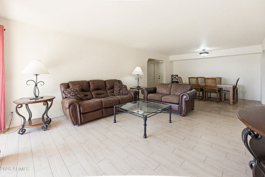 PRIME SCOTTSDALE LIVING in this UPGRADED GROUND-FLOOR unit with a smart SPLIT floor plan & expansive open living space. STORAGE is exceptional with dual closets in both bedrooms, including walk-ins. The kitchen is BEAUTIFUL with granite countertops, generous prep space, and clean finishes, flowing seamlessly into the living area. ALL TILE FLOORING-NO CARPET!  In-unit stackable washer/dryer. Optional furnishings available for a true turnkey setup. Large back patio for the plant lover! RESORT-STYLE community amenities include heated pool & spa, fitness center, BBQ areas and beautifully maintained grounds. Unbeatable location minutes to Old Town Scottsdale, dining, shopping, and Loop 101. 10 minutes to the airport & Salt River Fields, 25 minutes to Downtown Phoenix. Enjoy a turnkey Lifestyle!