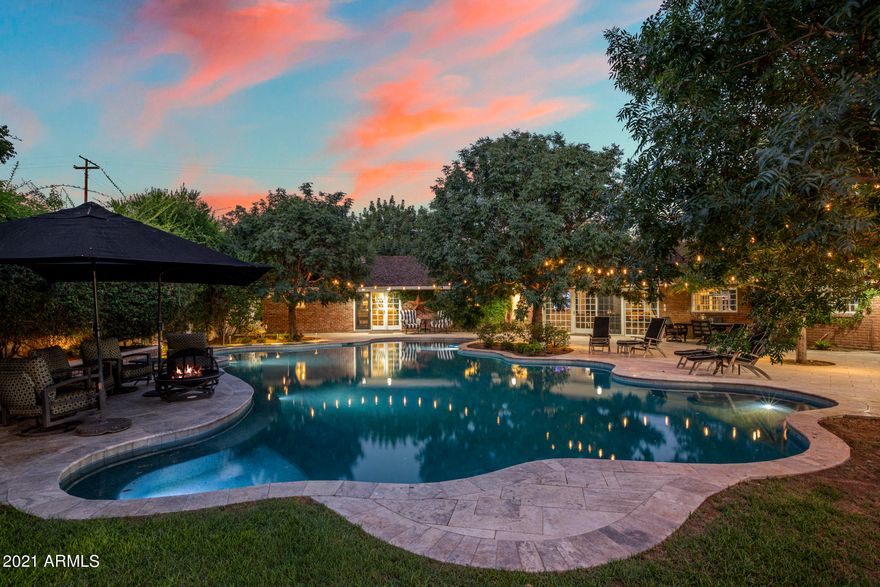 Just steps from the historic Murphy Bridle Path & nestled on a privately gated lush corner lot sits the most charming modern ranch home in the North Central Corridor.  Interior design by renowned celebrity designer Britney Simon, the property exudes character along with a well-appointed casual elegance that combines modern luxury and finishes with the warm comfortable feeling of home.** Seller has invested nearly $2 million in remodeling and landscaping upgrades. ** Open concept living where the kitchen and family room connect while overlooking the outdoors.  Top of the line fixtures throughout including the chef's kitchen which boasts state of the art appliances, an over-sized island, eat-in breakfast area & built in bar.  The master suite is spacious and bright with a lavish bath area & two closets.  Her closet is a dream with custom built in's with glass shelving, under lit lighting and a stylish center island vanity.  Guest bedrooms are equally expansive with ample closet space and en-suite baths. The backyard is picturesque with immense trees and twinkling bistro lights that frame a free form shape pool resembling a pond with a beach entry and separate access to the primary suite. The garage is a car lovers dream with a workshop, limitless storage and ample space for up to 5 vehicles.  Take a stroll down the Bridle Path to Uptown Farmer's Market, visit A.J's fine foods,  shop at Uptown Plaza or feel free to walk or order take out from any of the local favorites: Postinio's, Joyride, Windsor, Federal Pizza, Chula Seafood, St. Francis, Kreme Coffee and many more. Watch the APS light parade and Fiesta Bowl Parade from your front lawn.