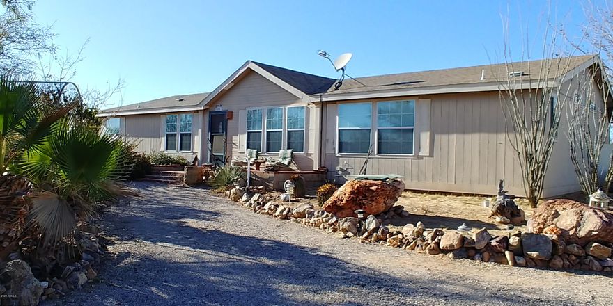 If you like entertaining, this home is for you! There are so many patios, courtyards and scenic spots on this property. There is a Tiki bar in the Arizona room and a working antique wood stove will be replacing the current one. The master suite is huge! The bedroom has room for desks, sitting area or excersize area. There is a dual master bath! One side has a shower and a single sink, the other has a garden tub, separate shower and 2 sinks. Outside you will find a 3 car garage. 2 load from the front and one from the side. It has a wood stove too! All of this and a private well! This home will not last. Call today for your private showing. Buyer cancelled before doing any inspections. The buyer has decided to live in a 5th wheel and build.