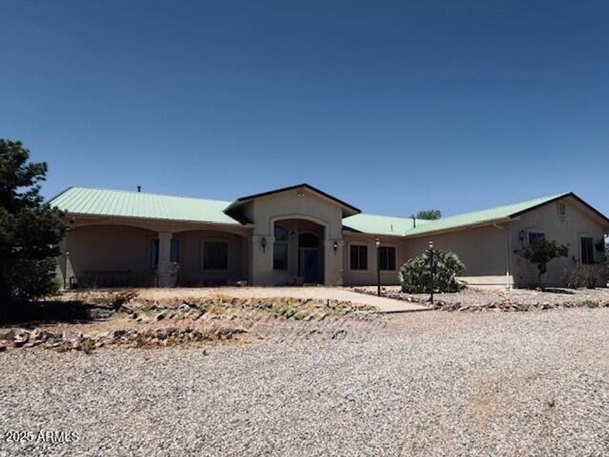 This home and guest house sits on 4.13 acres with mountain views. Main House is 3,694 sq ft.  The guest house is 884 sq ft There is a 30 x 40 shop with RV hookup- 
this home is perfect for multi-generational living, home -based business or income potential. Main house features 4 bedrooms, massive walk-in closet. media room (ideal for second primary suite) family room with a pellet stove for cozy evenings and custom kitchen.
. Guest house includes 1 bedroom, kitchen, laundry, covered patios and an extra-large garage.  Home features solar panels & ample additional covered storage behind the shop. Mature trees and wide-open skies! This home was built by the custom home builder for the builder! 
 This home is a fixer-upper with a lot of potential.