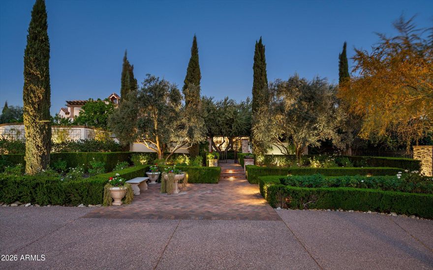 Fully remodeled and masterfully reimagined with interiors by the renowned firm Nate Berkus Associates, this more than 7,000-square-foot residence blends timeless European elegance, impeccable craftsmanship, and curated luxury. Set on expansive private grounds, the estate offers a rare opportunity to experience resort-style living in a home of extraordinary design and refined sophistication.

Soaring ceilings and walls of glass fill the home with natural light, highlighting its grand scale and refined architectural detailing.  Rich wood and limestone flooring create warmth and continuity throughout, while six hand-carved limestone fireplaces anchor the living spaces and reclaimed wood accents add depth and timeless character. The thoughtfully designed floor plan features four expansive en-suite bedrooms and four-and-a-half baths, each appointed with bespoke materials and elevated finishes. The private primary wing serves as a true sanctuary with two separate primary bathrooms, two generous custom closets, and a secluded courtyard with a private outdoor shower for a tranquil outdoor escape. 

At the heart of the home, the kitchen pairs beauty and performance. Custom cabinetry, slab marble surfaces, and a dramatic marble-and-bronze island form an architectural centerpiece, complemented by Sub-Zero refrigeration and a statement La Cornue range. A fully equipped secondary kitchen adds exceptional convenience for entertaining or daily living. 

The fully enclosed grounds evoke the feel of a private resort, with lush gardens, mature roses, vibrant blooms, and citrus trees, alongside a tranquil koi pond and wood-fired pizza oven. Multiple covered entertaining areas, artificial turf, and a dedicated greenhouse enhance both charm and versatility, while the infinity-edge pool, framed by limestone decking and a picturesque pergola, creates an idyllic setting for relaxation and entertaining. Two garages with space for 4.5 cars complete the offering. 

Located within walking distance of the iconic Arizona Biltmore, this exceptional estate offers a rare blend of privacy, scale, and resort-inspired living.