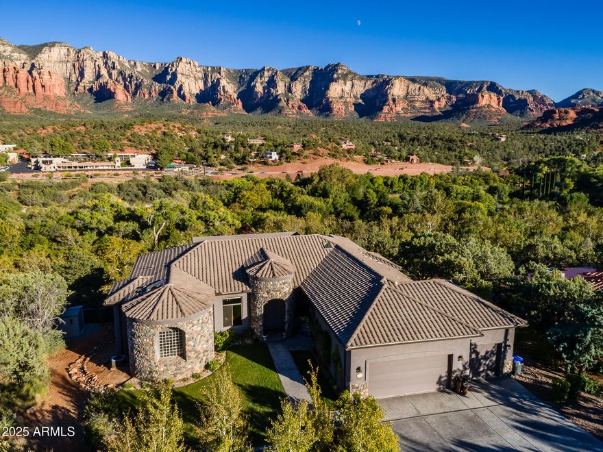 Experience one of Sedona's most extraordinary luxury estates, where jaw-dropping panoramic red rock views meet impeccable modern craftsmanship. Completed in 2018(certificate of occupancy attached), this single-level masterpiece blends soaring 12-ft ceilings, amazing views through the windows, and high-end finishes throughout. The open-concept design flows effortlessly into a stunning chef's kitchen equipped with elite Miele, Sub-Zero, and Wolf appliances. Offered fully furnished and turnkey. No HOA. The lavish primary suite is a serene retreat with breathtaking views, a private deck, massive custom closets (including a His&Her), and a spa-worthy bath featuring a steam shower and jetted tub. Guests will love the three generous en-suite bedrooms, each with beautifully appointed bathrooms. Step outside to a 54-foot entertainment deck overlooking Oak Creekcomplete with an outdoor fireplace, dining space, and BBQ setupperfect for stargazing or savoring Sedona's magical sunsets. The fun continues outdoors with a spa, putting green, bocce court, bean bag toss area, and tranquil Zen gardens with dual water features.

This home also features a lower-level recreation room, custom designer lighting, state-of-the-art sound system and fully landscaped grounds with an organic garden and rainwater recapture system.