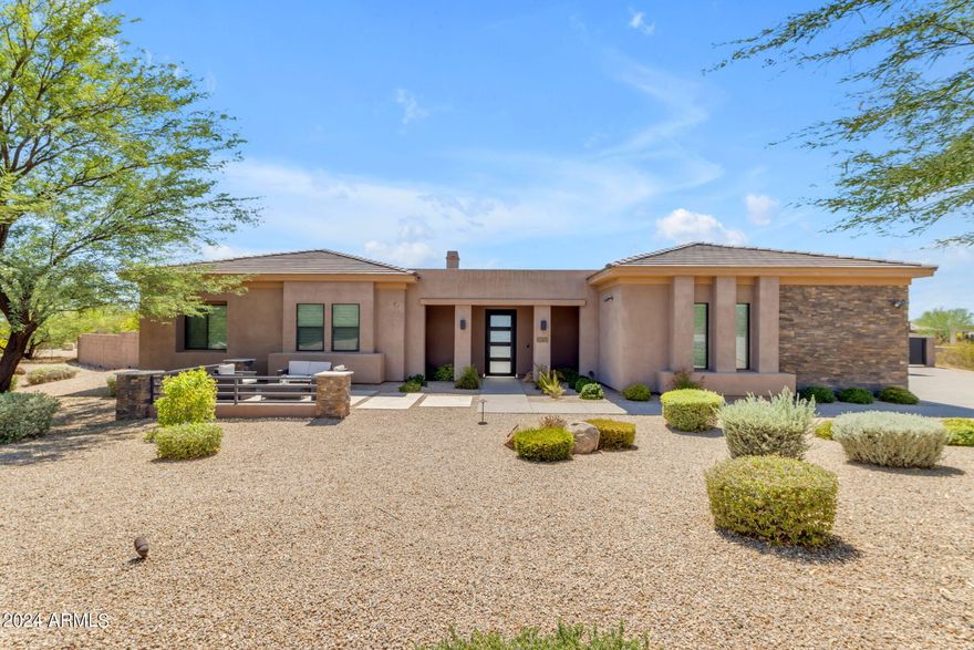 Incredible modern masterpiece on over an acre in the intimate gated community of Turquesa. It's rare to find a home in such great condition, feels & looks like new! This 5086 sq. ft. home features elegant open living w/ a stunning fireplace wall, unique bar area, and detailed ceiling. The exceptional kitchen has a massive 12x6 ft island, Sub Zero refrigerator/freezer and 48'' Wolf gas cooktop & walk in pantry. Seamlessly blend indoor & outdoor living with huge disappearing glass doors, perfect for entertaining. Located in sought-after North Scottsdale, close to 5-star resorts, world-class shopping, dining, hiking trails, and multiple golf courses. Just 10 minutes to the 101 or Cave Creek. Backyard oasis retreat w/pool, spa, BBQ, synthetic grass, garden, and more! Enter the Casita through the private courtyard. All guest rooms are spacious w/private baths & walk in closets. Private office and an extra room perfect for game room, extra living area or more. Home has all the conveniences you would expect, RO system, Soft Water Conditioner & more. 4 car garage & large driveway plenty of room for all your guests! Double gate to back yard. Spacious side area with garden & turf. Home is perfect for gatherings & entertainment! Home for the most discerning of buyers!