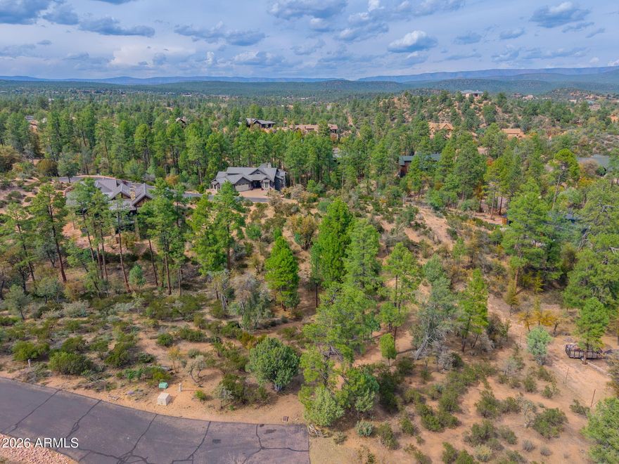 Exceptional homesite tucked away at the end of a quiet cul-de-sac within the gates of the prestigious Rim Golf Club. This .41-acre parcel offers an ideal setting for a custom single-level residence, surrounded by towering pines and the natural beauty that defines Rim Country living. The adjacent Lot 240 is also owned by the same seller and available for purchase, presenting a rare opportunity to secure nearly one acre of privacy in one of Payson's most sought-after private golf communities.