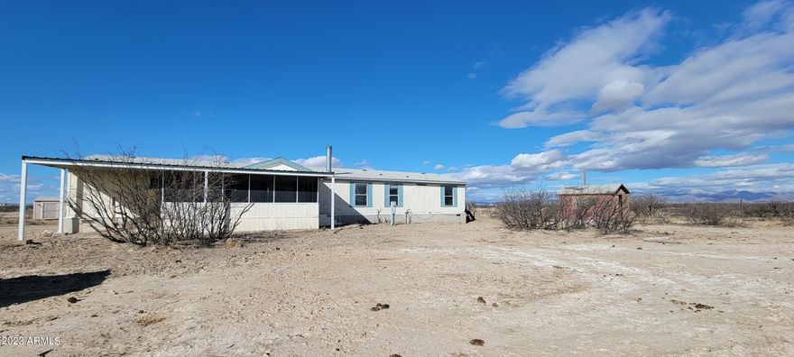Here is a great opportunity to purchase a large home with a barn and private well on just under 40 acres at a great price. The home features a split plan with a large kitchen and family room. The secondary bedrooms are good sized and the laundry is located by the secondary bedrooms. There is a large living room with a real fireplace for the cold winter nights. The master suite is HUGE and boasts his and hers baths with a large walk thru closet in between. You will enjoy the screened patio on the front to watch the amazing Arizona sunsets. The property is fenced and cross fenced as well. This is an AS IS sale.