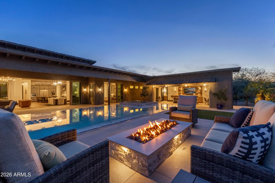 This iconic former Monterey Model Home sits majestically on an elevated homesite in the prestigious Trilogy at Verde River offering both Privacy and Mountain Views.  Featured in a number of Architectural and Interior design publications, this Valencia Plus model is designed with timeless high-end finishes and a floor plan perfect for entertaining family and friends.  The home offers 5216 sq ft of luxury living including 5 Bedrooms, 5.5 baths, den/office, Game Day Mancave with beverage center and kegerator, two bedroom attached Casita with separate entrance, and a spectacular party ready Pool Cabana. No detail, either in the floor plan, amenities or quality of finishes has been overlooked.  The spacious home is thoughtfully laid out with a split floor plan featuring all ensuite Bedrooms and walk-in closets, a 30 foot Glass Wall that opens the great room to the stunning pool and view, as well as 10ft multi panel doors in the owner's suite, kitchen, office and living room that bring the outdoor areas inside to this spectacular home.  The outdoor living space is magnificent with 2000+ sq ft of covered patio, zero edge spa and pool, complete with swim jets, and two separate outdoor kitchen/grilling areas which all provides the year-round outdoor living you're looking for in Arizona.  Exquisite finish details include beautiful wood beams, wood floors, 17ft ceilings, 8 inch baseboards, and a satin and suede bi-level kitchen counter in a Chef's dream kitchen with upgraded appliances.  The expansive primary suite features a cozy sitting area, a large ensuite master bath with wet room, custom closet with plenty of storage and calming views of the pool.  Other noteworthy features of this extraordinary home include a large hobby/laundry room, wet bar adjacent to great room, large custom pantry, and outdoor dining nook and grill area with direct access to kitchen. 
 This home is perfection inside and out!

Trilogy at Verde River offers upscale Resort living at its finest and the very best of all possible worlds, close to the conveniences of affluent North Scottsdale, yet secreted within the pristine privacy of the Sonoran Desert. 
The amenities are World Class with Tom Lehman inspired eighteen-hole Golf course, tennis courts, pickle ball courts, and bocce ball, heated lap pool and Resort style swimming pool, hot tub, Afterburn fitness center, Helen's demonstration Kitchen for cooking classes and a 7.5 acre dog park. The community center has casual poolside dining at Eddy's Diner and gourmet dining at award-winning Needle Rock Kitchen and Tap, Alvea Spa with full-service Salon and Spa amenities, Art Loft and events center. Trilogy at Verde River is adjacent to the Tonto National Forest and is situated in the middle of miles and miles of hiking and biking trails. 
Whether you're seeking a second, winter home, or will live here year-round, Trilogy at Verde River is an ideal distance from the hustle and bustle of North Scottsdale. You'll love the Resort living!
What memories will you make?