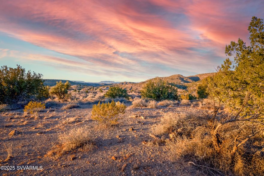 Welcome to Arizona's wine country. This JoJo Lane 3.5 acre lot is near the Page Springs wineries and grape growing operations. The 3.5 acre lot has a large flat portion of land that is easily buildable and has big expansive views in all directions. Lot overlooks Oak Creek and is high enough in elevation to view the Red Rocks of Sedona. Sunsets over Mingus Mountian are breathtaking and the privacy of this lot will make you feel a world away from the hustle of city life. The neighboring lot has a pedestrian easement into the National Forrest for a short walk to private hikes and experiences with the wildlife found in this area. Gravel road access to lot is good and a short drive from Page Springs Rd.