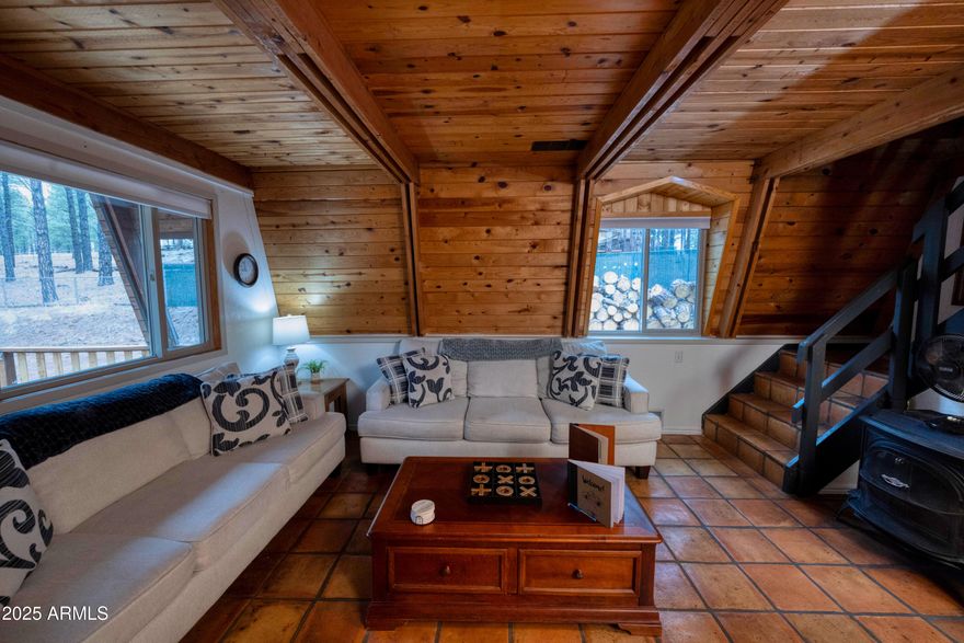Imagine waking to the scent of ponderosa pines and looking out into thousands of acres of untouched national forest. Welcome to your Sherwood Estates refuge, just 10 minutes from Williams. This charming, fully furnished cabin borders the Kaibab National Forest--literally making the wilderness your backyard.

The bright, open-concept main floor flows seamlessly onto an expansive back deck, perfect for stargazing at 7,000 feet. On chilly nights, the wood stove creates a cozy ambiance that naturally warms the entire home. With a proven track record as an Airbnb, this turnkey property is a lucrative investment or a dreamy private escape. Best of all? Horses are welcome, with endless forest trails right outside your door.