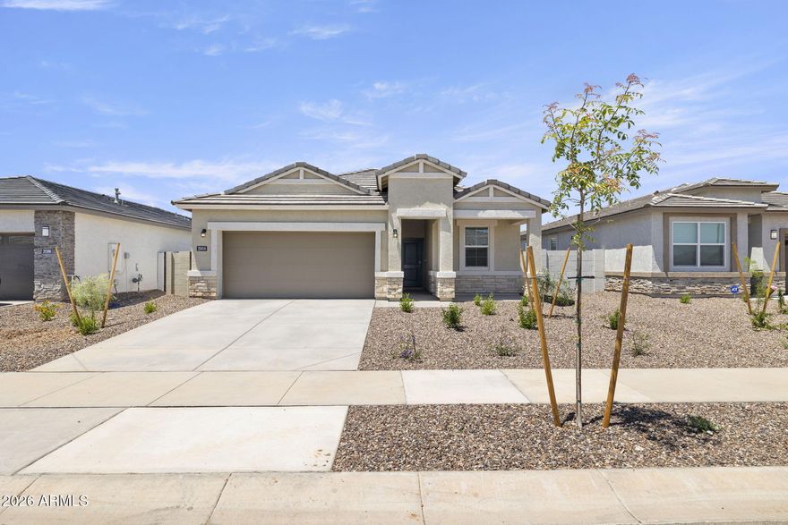 This beautifully upgraded home features a bright, open floor plan designed for modern living. The kitchen showcases warm burlap shaker cabinets, quartz countertops, a classic subway tile backsplash, & upgraded stainless steel appliances including range, oven, dishwasher & microwave. Under cabinet lighting adds both ambiance & functionality. Throughout the main living areas, enjoy durable 12x24 inch block lay tile, while upgraded carpet provides comfort in the bedrooms. Elegant 8 ft interior doors enhance the sense of space & style. A sliding glass door opens to the patio, seamlessly blending indoor & outdoor living, perfect for entertaining or relaxing at home. Pictures may represent other homes.