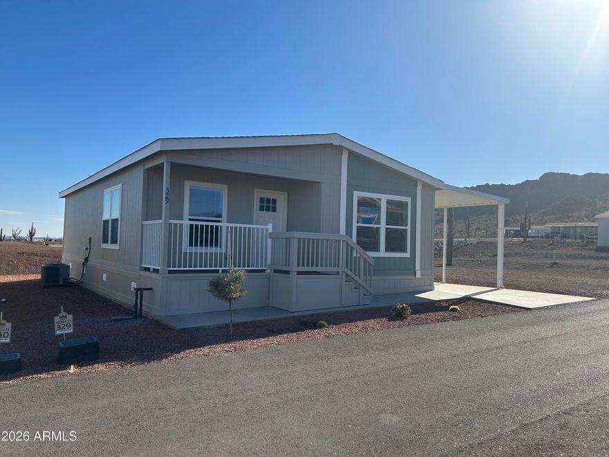 This 2 bedroom/2 bath home is move-in ready and offers you 1093 square feet of living space located at the beautiful Picacho Peak RV Resort. Where the views are spectacular, and the people are as warm as the Arizona sun. Built by Clayton Homes in Buckeye, AZ, this manufactured home features eBuilt by Clayton which includes 2 x 6 outer walls with R-21 insulation,  Smart Comfort HVAC Heat Pump, Argon Gas Low-E Windows, Ecobee Thermostat, Samsung Energy Star Kitchen Appliances, Water Saving Bathroom Fixtures, LED Lighting and is a DOE Certified Zero Energy Ready Home. The home also includes a large kitchen island, a mud room with space for a washer & dryer and a 12' x 44' concrete slab with attached carport awning plus a 10' x 10' shed.  55+ Background check required