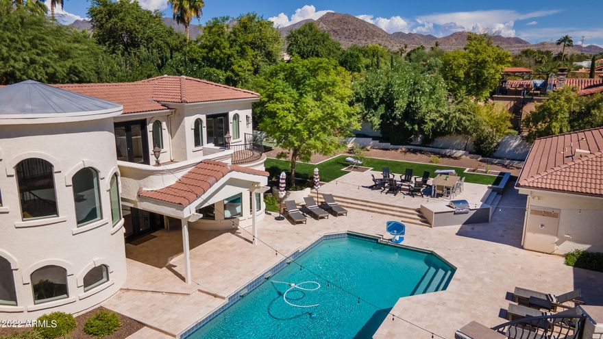 Absolutely stunning resort style property with tons of on-trend features and a detached 2,200 sqft full guest house. The immaculate backyard has an extended covered patio with travertine pavers throughout, built-in BBQ, sparkling pool and spa, outdoor shower, faux grass lawn, pickle and basketball court, firepit with seating area, upstairs view deck with fireplace, and dual  12' RV gates. The detached 8 car drive thru garage is climate controlled and has a 1,500 sqft shop, epoxy flooring, pneumatic air system, air compressor, zero clearance doors, living/office space, and RV hookups and pump out. The Master suite has double door entry, fir wood and beamed ceilings, bonus space, dual closets, meditation room, and a full bathroom with jetted tub, walk-in shower, and bidet. The eat-in kitchen incorporates slab granite counters, tile backsplash, maple cabinetry, island, stainless appliances, and double ovens. Other features include stunning mountain and city light views, fresh paint throughout, vaulted ceilings, living room and family room fireplaces, 6 AC units and a 3.5 car garage with epoxy, cabinets, central vac, storage, and shop. The detached full guest house is 2,200 sqft and boasts a kitchen, game room, 2 bathrooms, gas fireplace, loft area, balconies, and two large bedrooms.