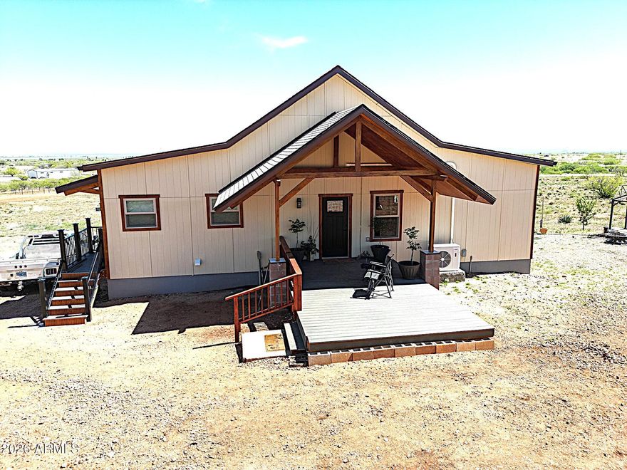 Bring your most discerning buyer!  Beautifully appointed custom home surrounded by stunning mountain views!  A horse lover's dream w/unlimited riding available w/access to state land directly from the property.  This 2023 built 1,472 sq. ft. home has all the luxury & attention to detail for comfortable living.  Great room w/exposed beam ceiElegantly appointed kitchn w/stainless steel appliances. & granite countertops & reverse osmosis. Full basement for additional storage, wine cellar or workshop/hobbies.  Private well.  Two stall barn. Connex for tack storage/feed room. Round pen. RV hookup.  Front deck & a FABULOUS back balcony for star gazing & to marvel at the incredible views that surround this property. Located at the end of the road. Come home to quiet, country living at it's finest