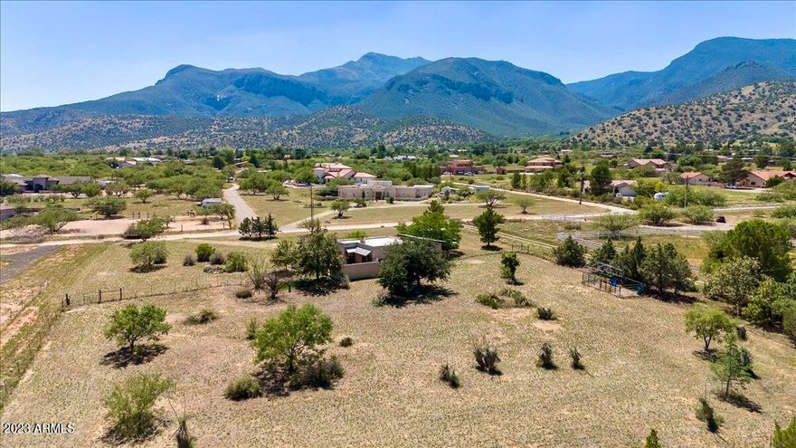 GREAT OPPORTUNITY with this custom, site built bungalow-style home sitting on gorgeous acreage nestled near the Huachuca Mountains. Meticulously maintained  2 bedroom, 1 bathroom home has newer kitchen appliances and copper countertops, high ceilings, exposed beams, luxury vinyl plank flooring throughout, beehive fireplace and more. Large walk-in closet in primary bedroom. In ground spa in back courtyard. Huge gated carport with storage. Laundry room with utility sink and cabinets. Horse property with corral. Dog run with turf.  RV parking.
Perfect income opportunity to use for short term rental or guest house while building your dream home on this large 2 acre property.