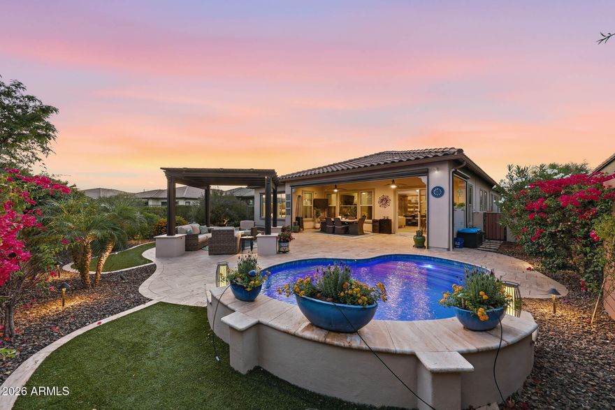 STUNNING! Like-new 2018 Montage model featuring 2 PRIMARY suites, 2.5 BATHS, a GENEROUS den/office that could easily be utilized as a 3RD bedroom, & over $250K in PREMIUM upgrades, plus a NEWER resort-style POOL! Situated on a PRIVATE lot w DESIRABLE north/south exposure & a fully fenced backyard, this IMMACULATE home offers 10-foot ceilings, wood-look tile throughout (no carpet), CUSTOM window treatments, WET BAR & DESIGNER finishes at every turn, CUSTOM closet organizers, and PRIVACY PANELS in the backyard. The chef's kitchen is BEAUTIFULLY appointed w a 42'' Sub-Zero built-in refrigerator, Bosch dishwasher, GAS appliances, CUSTOM cabinetry with soft-close drawers and pull-outs, OVERSIZED crown molding, a CUSTOM island, granite countertops, and a DESIGNER tile backsplash. Both bathrooms showcase LUXURY upgrades including Toto Washlet toilets, framed mirrors, and HIGH-END finishes. Step outside to your backyard OASIS featuring an EXTENDED travertine patio, pergola with a TRAVERTINE conversation area, built-in BBQ with refrigerator and ICE MAKER, zipper patio shades, NEWER sparkling pool, and LOW-MAINTENANCE synthetic turf in both the FRONT and BACK yards--perfect for entertaining or relaxing year-round. Additional upgrades include SOLID-CORE doors, OVERSIZED baseboards, paver driveway and walkway, a 4-foot EXTENDED insulated tandem garage with epoxy floors, BUILT-IN storage and utility sink, central vacuum, surround sound, UPGRADED lighting, PREMIUM ceiling fans, soft water system, reverse osmosis, and CUSTOM built-ins throughout. Exterior painted in 2026 and new irrigation system in 2025 ! METICULOUSLY maintained and truly MOVE-IN READY--this EXCEPTIONAL home is a MUST-SEE!