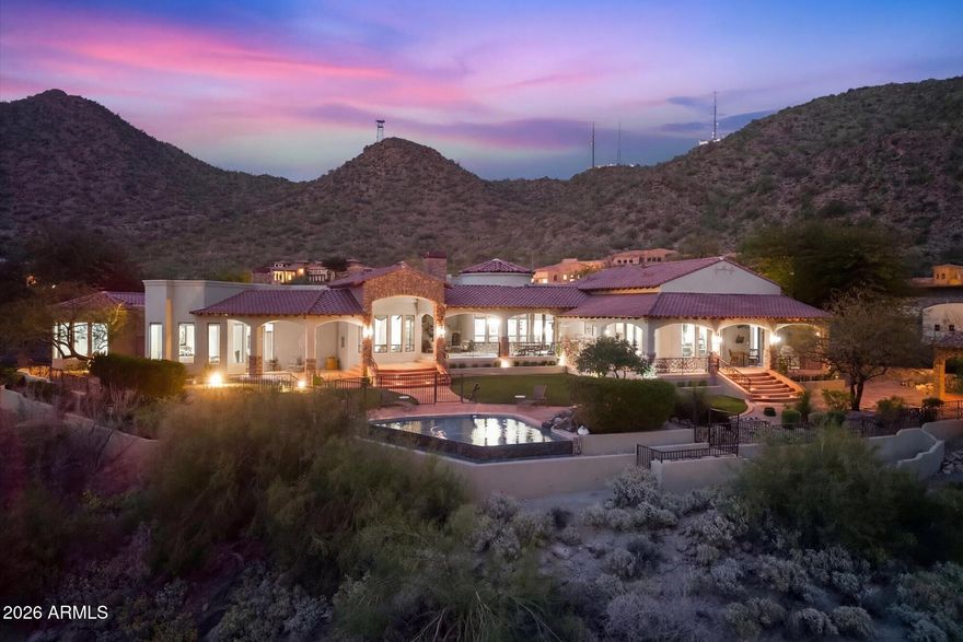 An inaugural opportunity to acquire, this remarkable Diamond Point estate sits atop one of the highest and most coveted vantage points in Las Sendas. Positioned on a rare, level 1.68-acre homesite with ideal north-south exposure, the 7,251 total sq. ft. residence, offering over 10,000 sq. ft under roof, captures some of the community's most unobstructed panoramic mountain and city-light views from nearly every room and across its expansive outdoor living spaces.  The 6,443 sf main residence is designed for elevated entertaining, anchored by an extraordinary chef's kitchen showcasing authentic leathered quartzite waterfall countertops across three statement islands, a dramatic wine tower, dual refrigerators, dual dishwashers, and refrigerator drawers, all complemented by custom cabinetry and premium appliances. Grand interior spaces extend effortlessly outdoors, creating a spectacular setting for gatherings both intimate and grand.  Curated for hospitality, amenities include a private theater, entertaining lounge, full bar, and a climate-controlled wine room with capacity for 600+ bottles.  2 ensuite guest bedrooms accompany a magnificent primary retreat spanning more than 1,500 square feet, complete with an intimate sitting area w/ fireplace, private fitness room, dual oversized walk-in wardrobes, and a spa bath with steam shower. The outdoor experience rivals a luxury resort, highlighted by a designer double negative-edge pool and spa, private putting green, and multiple covered terraces framed by breathtaking sunsets and brilliant Valley lights.  An 808 sq. ft. detached guest house with 2 bedrooms, two baths, a great room, and full kitchen ensures comfort, privacy, and independence for extended stays.
Set against the dramatic backdrop of the Usery Mountains, Las Sendas offers a rare blend of tranquility and access, moments from major routes and approximately 20 minutes to both Sky Harbor and Mesa Gateway airports. Championship golf, tennis, resort pools, trails, lakes, the Salt River, and protected preserves define the lifestyle.  An extraordinary opportunity where scale, privacy, and commanding views place you at the pinnacle of Las Sendas.