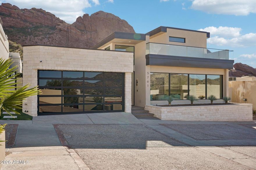 PRICE IMPROVEMENT!!! Truly unmatched elegance in the extremely desirable guard gated community of Echo Canyon. This newly constructed architectural masterpiece redefines modern elegance; curated with a soft neutral palette, modern lines & a seamless blend of sophistication & timeless beauty. Thoughtfully designed, the exterior elements flow seamlessly into the home; floor to ceiling 6'' stacked limestone leads you through the glass pivot door into the great room with in ground uplighting, clear story windows, stunning mountain views, gas fireplace, walk-in temperature-controlled wine room & direct access to your private courtyard. Designed for entertaining, the kitchen features an expansive island with breakfast bar seating, leathered Taj Mahal quartzite countertops throughout, alabaster pendulum lighting, top-of-the-line Thermidor appliances & a spacious butler's pantry. The formal dining area is equipped with a walk-up wet bar complete with a wine fridge & ice maker. The primary suite is perfectly appointed with direct access to the courtyard; featuring custom built in accent wall, gas fireplace & a spa-inspired bathroom that exudes tranquility with dual floating vanities, soaking tub, tiled walk in shower & walk in closet with custom textured built in cabinetry. The remaining bedrooms are located on the main level, with private on suite baths. The second level of the home is a dedicated flex space, which could be converted to a 4th bedroom, office OR entertainment area with a walk up bar, private bathroom & access to the observation deck where you can soak in panoramic views of Camelback Mountain's North elevation, all of Paradise Valley including the Phoenix skyline & vistas stretching as far as Carefree/Cave Creek! 

The home is designed around the resort-style courtyard offering seamless indoor-outdoor living, featuring a built-in grill, rim-flow spa & fire pit all designed for the ultimate relaxation & entertainment with breathtaking views of Camelback Mountain & the iconic Praying Monk formation as your center piece. 

Living in Echo Canyon comes with unmatched amenities: 24-hour manned security, a community clubhouse, a heated pool & spa, tennis courts & private access to the Echo Canyon trailhead all just steps from your front door. 
Located on the border of Phoenix & Paradise Valley, this home is minutes from premier dining, upscale shopping, The Global Ambassador, The Village, world-class golf courses & all that Phoenix & Paradise Valley has to offer.
Don't miss the opportunity to call this architectural masterpiece your own & experience the pinnacle of refined living in the heart of Echo Canyon.