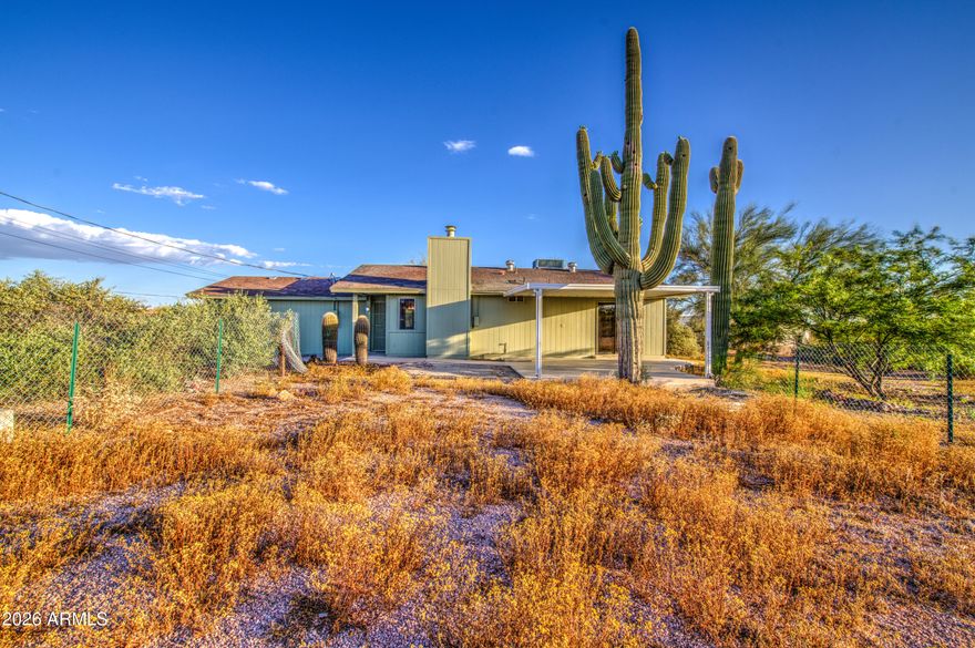 This Beautiful property has not only been completely renovated inside and out, but it has the most breathtaking view possible of Superstition Mountain. The kitchen has appliances that have never been used. 2 refrigerators, updated counters in this eat-in kitchen. Living room has wood burning fireplace. Both bathrooms are completely renovated. LVT flooring throughout the entire home as well as new lighting and fans. Down 2 steps to the 3rd bedroom and great room with a wall of windows looking right at the mountain. Roof and A/C are 5 yrs old. Large separate Storage/workshop with electric, all on 1.25 acres of natural desert landscape. Did I mention the view? Come see this. You'll love it.