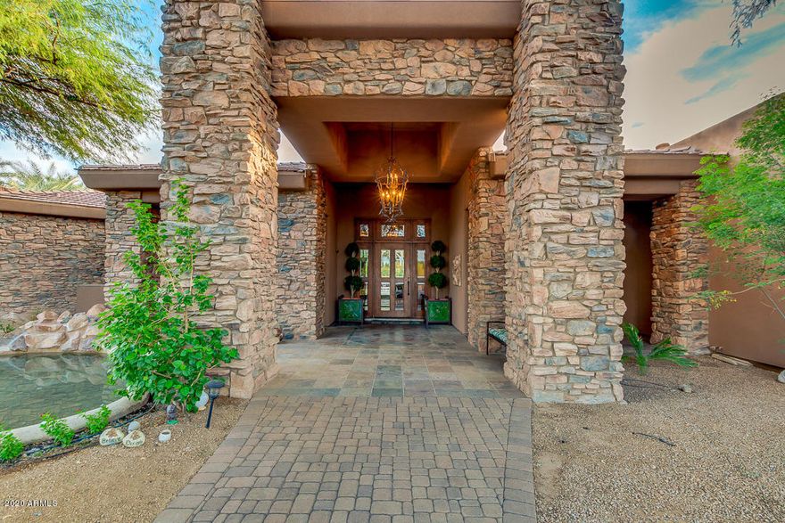 Elegant grand-scale entertaining & family living in this sought after private oasis minutes from the Ritz-Carlton, shopping, and restaurants. Nestled in a quite cul-de-sac with gorgeous Mummy Mountain Views and WALK-OUT BASEMENT with high ceilings.  Split floor plan w/luxurious finishes including chef's kitchen equipped w/Viking/Subzero/Fisher Paykel appliances/Alder cabinetry & slab granite counters. Impressive master suite w/2-way fireplace/dressing area/dual vanities and enormous master closet.  All bedrooms with en suite bathrooms. Alder-appointed office w/built-in bookcases, billiards/game room, library/cigar room/studio quality home theater/lighted sport court/heated pool/spa/grassy play yard, energy efficient, all on  privately gated north/south lot.