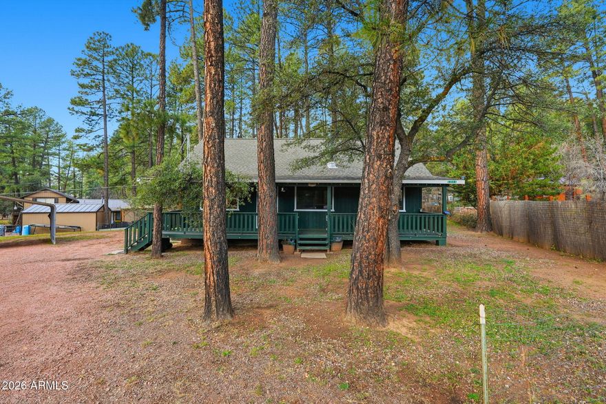 Located in the pine-lined Shady Lane Estates of Strawberry, this furnished mountain residence offers refined comfort in a serene natural setting. Positioned on a quiet cul-de-sac across from Strawberry Pond, the home features vaulted ceilings, a welcoming great room, and a free-standing wood-burning fireplace that anchors the space. Thoughtful updates include fresh interior and exterior paint, new plumbing fixtures, and stainless steel kitchen appliances. A spacious covered front patio invites relaxed mornings and tranquil evenings, while covered parking and close proximity to town complete this elevated mountain retreat. With cool summer temperatures, walkable surroundings, and serene views, this property appeals to short-term guests year-round. The cul-de-sac setting adds privacy and space, while the furnished interior allows for a turnkey setup. Whether used personally or as an income-producing mountain getaway, this Strawberry cabin checks all the boxes. Explore the historic Strawberry Schoolhouse, enjoy local food & markets, and discover nearby trails. Tonto National Bridge is 11 miles away, making this cabin a great escape for nature, history, and dining.