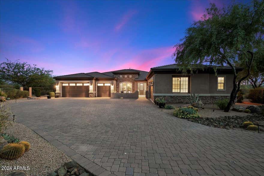Nestled in the serene Canyon Ridge Estates of Cave Creek, this stunning residence spans an expansive 4.8 acres, ensuring privacy and tranquility. The gated courtyard leads to a five-car garage with covered access to the home. The bright interiors begin with a reception foyer flanked by an office and a formal dining room. The main living area features a living room and a chef's kitchen under a coffered ceiling. Large sliding glass doors open to reveal a classic swimming pool with underwater seating beside a sunken bar, a firepit, and a detached one-bedroom guest house. The primary bedroom suite offers a spacious bedroom, a beautifully appointed bathroom, and dual fitted closets. With numerous additional bedroom suites and an executive office, this home epitomizes luxurious desert living. Home sold fully furnished as shown