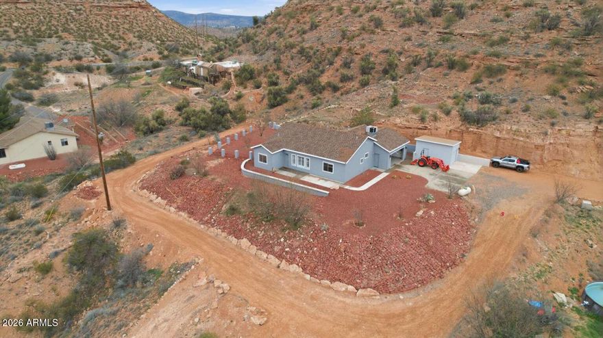 [INSTANT EQUITY] - Recently Updated Hillside Retreat Below Appraisal! Experience the perfect blend of modern comfort and Arizona beauty in this recently updated 3-bedroom, 2-bathroom home. Perched on 2.67 elevated acres with sweeping 360-degree panoramic views, the property has been refreshed to offer a crisp, move-in-ready lifestyle. Strategically priced below its recent appraised value, this is a rare instant-equity opportunity in the sought-after Sexton Ranch area. The open-concept 1,414 sq. ft. floor plan flows seamlessly, enhanced by a modern whole-home refresh. Notable updates include durable LifeProof™ plank flooring throughout living areas and new porcelain tile in bathrooms. Enjoy a bright, airy atmosphere courtesy of a fresh, neutral color palette (Warm Grays & Crisp Whites) that provides a perfect canvas for your personal style. The kitchen features new Corian countertops, new dishwasher, disposal and updated modern fixtures for a seamless look and easy maintenance. [Outdoor & Lifestyle:] Spreading over 2.6+ acres of private hillside with NO HOA offering plenty of room for toy parking, workshop space, or outdoor projects. Enjoy multiple outdoor living spaces perfect for sunsets, while native landscaping ensures the home is beautiful and easy to maintain. [Location:] Enjoy the peace of rural living close to Oak Creek and wilderness trails with the amenities of Page Springs Wine Country nearby. Enjoy easy access to the cultural hubs of Sedona and the conveniences of Cottonwood.